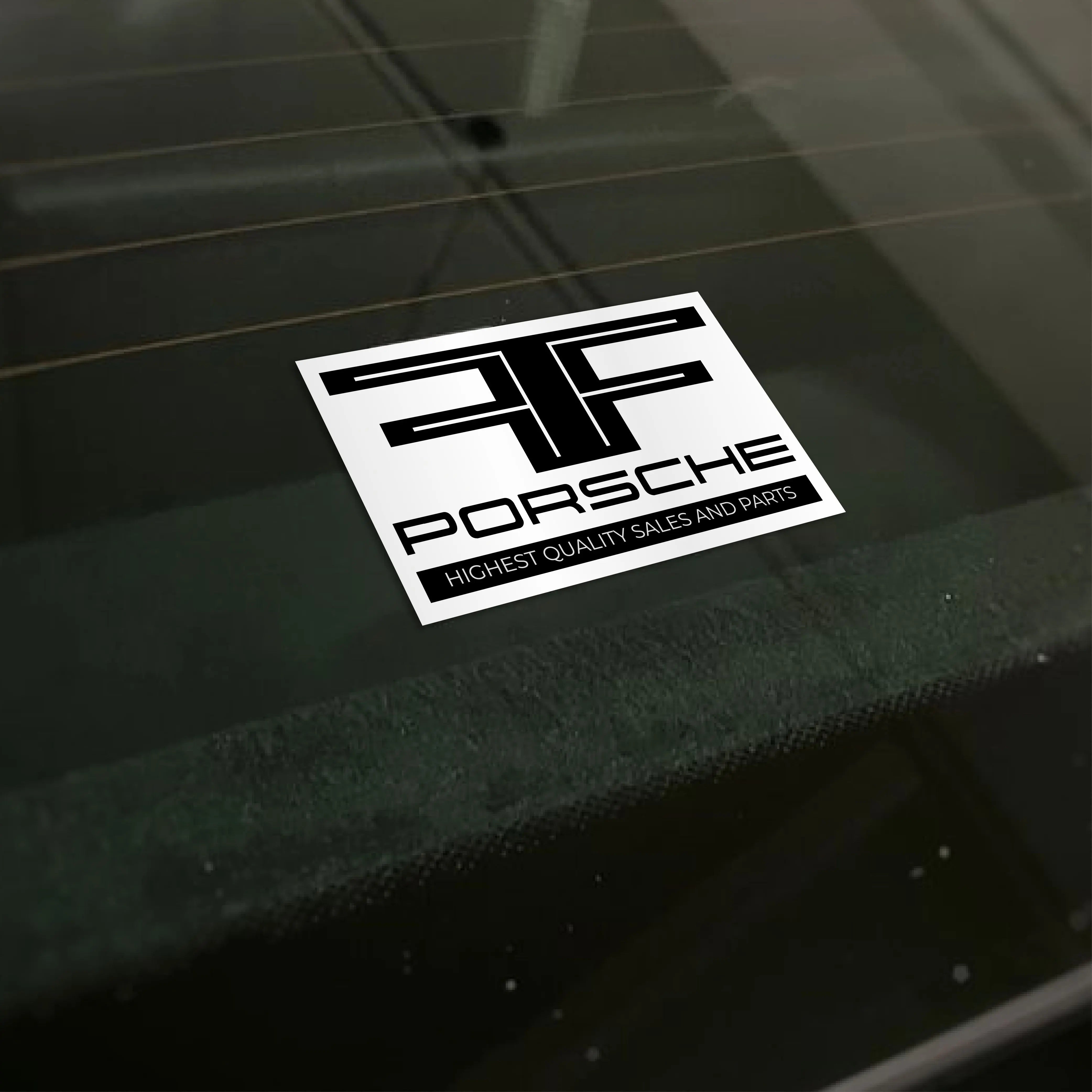 Porsche sticker on a car window highlighting quality sales and parts for car dealerships.